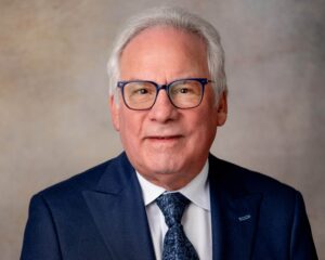 White haired man in glasses