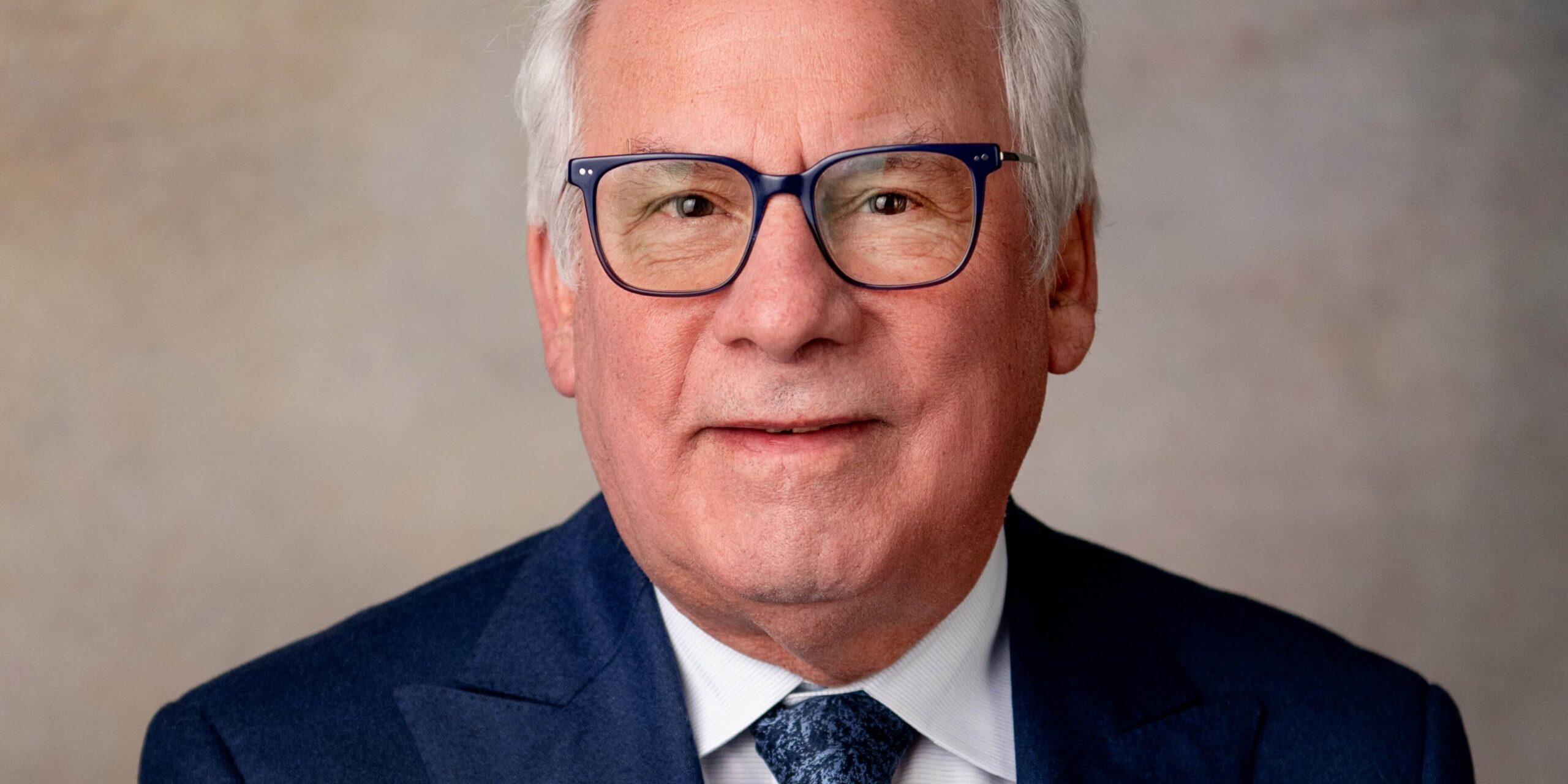 White haired man in glasses