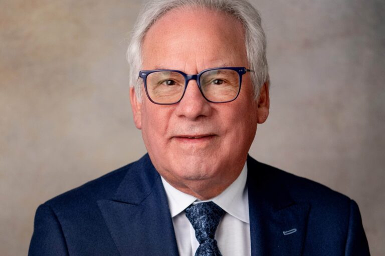 White haired man in glasses