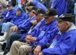 elderly Korean War Veterans sitting in a row