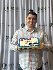 man holding graduation cake