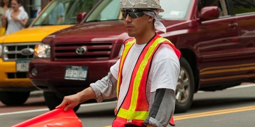 construction worker with orange flag