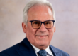 white haired man in glasses